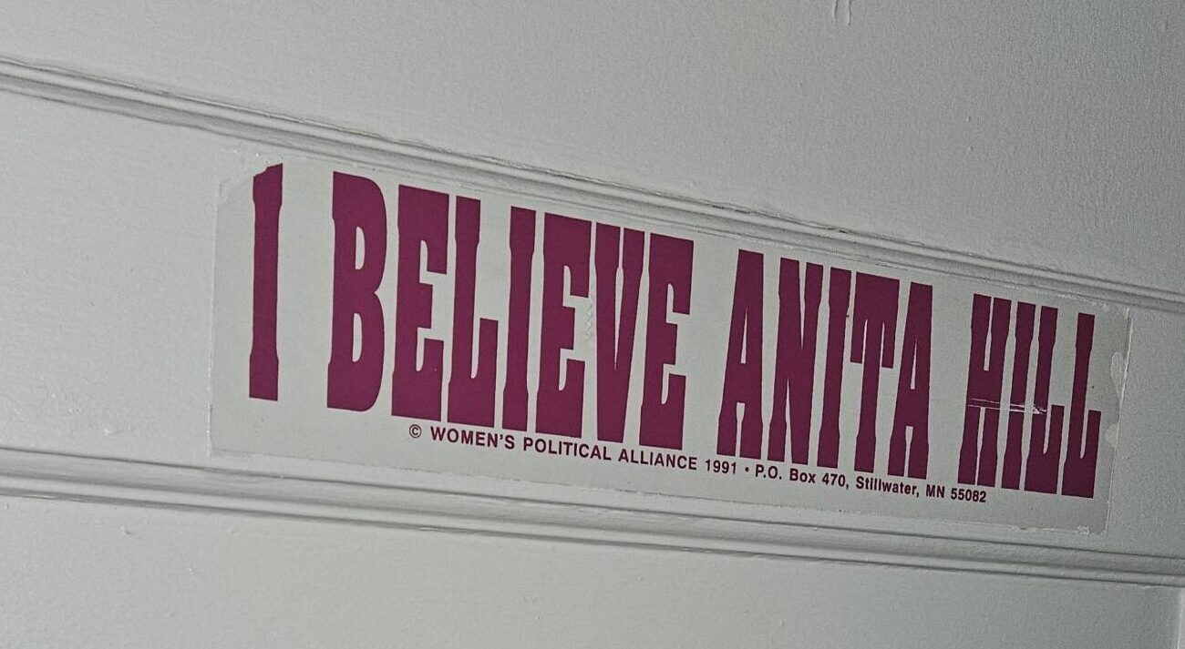 Sign on door that says; I believe Anita Hill. Women's Political Alliance 1991